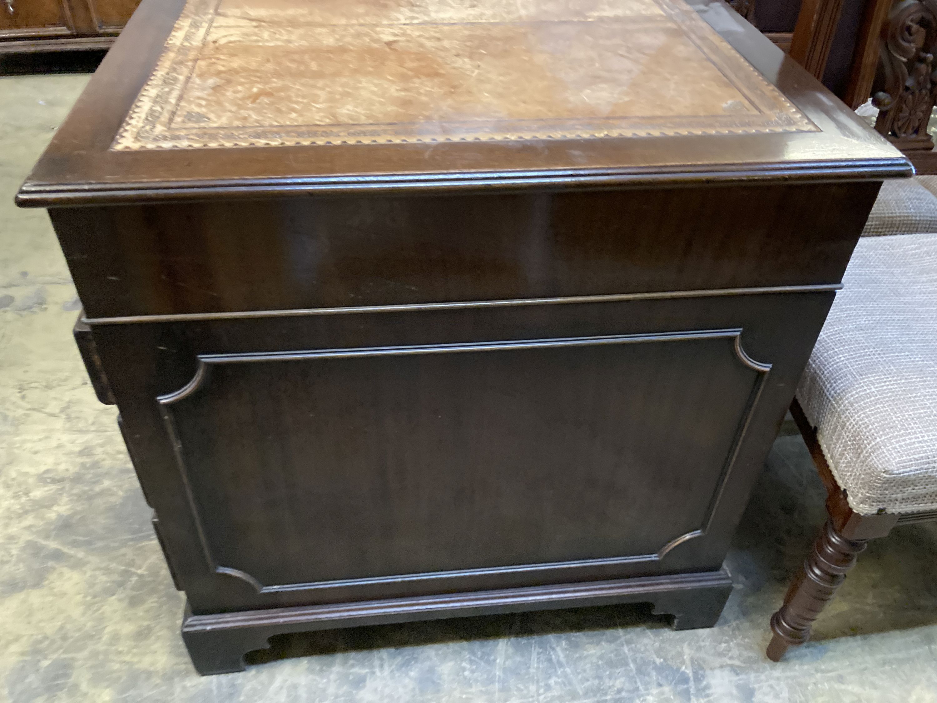 A reproduction mahogany pedestal desk, width 140cm, depth 76cm, height 78cm